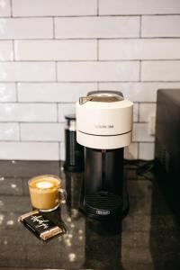 a coffee maker on a counter with a cup of coffee at Luxurious terrace home in heart of town in Bendigo