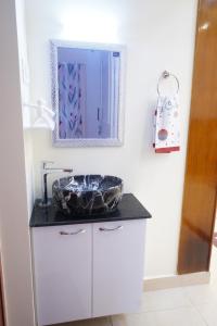 a bathroom with a sink and a mirror at Visalam service apartment in Chennai