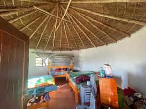 a room with a bed and a straw roof at Mantekuview Homestay 