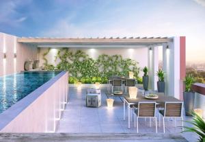 a patio with a table and chairs and a pool at The Paragon Explore Cape Town from a Stylish Home in Cape Town