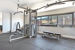 a gym with two treadmills and two machines at The Paragon Explore Cape Town from a Stylish Home in Cape Town