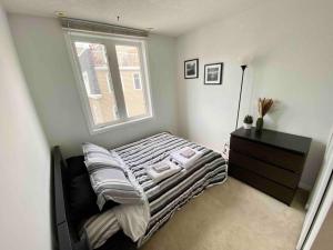 a small bedroom with a bed and a window at King West Private Rooftop Retreat in Toronto