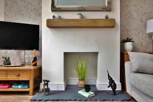 a living room with a fireplace and a tv at Finest Retreats - Shorelands in Prestatyn