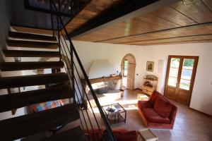 a view of a living room with a spiral staircase at Azienda Agricola Fornaci di Sotto in Castelnuovo Berardenga