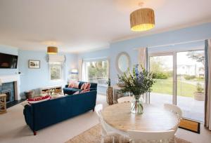 a living room with a blue couch and a table at Beautiful 5-Bed House in Port Isaac in Port Isaac