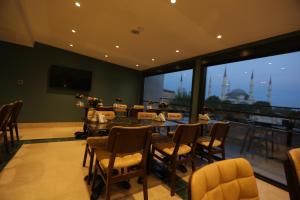 a dining room with a table and chairs and a balcony at HaciBayramApart in Istanbul