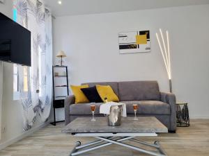 a living room with a couch and a table at Ecouter le silence à LALOUVESC in Lalouvesc