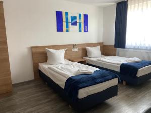 Postel nebo postele na pokoji v ubytování Sunny Hotel Straubing