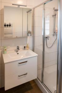 a bathroom with a sink and a shower at Appartements am Landschaweg in Weiz