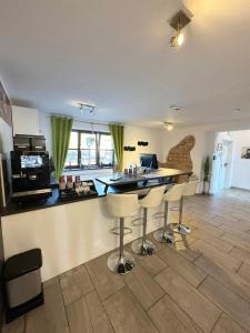 a kitchen with a counter and a bar with stools at Sunny Hotel Straubing in Straubing