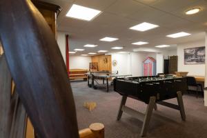 a room with a pool table and ping pong tables at Résidence Les Arches in Saint-Lary-Soulan