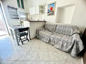a bedroom with a bed and a table and a desk at Suite Romolo Moreno 88 - Sanremo in Sanremo
