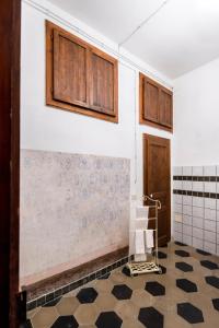 a room with a wall with wooden cabinets and a tiled floor at Welcomely - Casa Rodriguez in Iglesias
