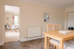 a kitchen with a table and chairs and a dining room at Grove Farm Bungalow and Annexe in Woodbridge