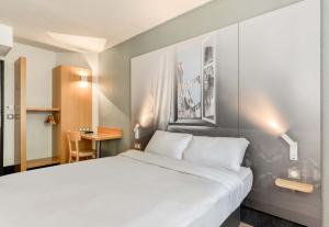 サン・ジャン・ド・ヴェダにあるB&B HOTEL Montpellier 1のベッドルーム(白いベッド1台、デスク付)