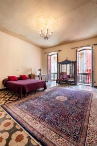 a bedroom with a bed and a large rug at Welcomely - Casa Rodriguez in Iglesias