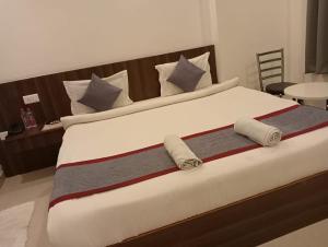 a large bed with two pillows and avertisement at HOTEL ORCHID in Lucknow