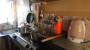 a kitchen with a counter top with utensils on it at Residential Superb Rooms, With Wifi, Netflix, Parking, Kitchen in Kampala