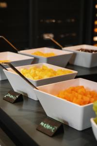 a table topped with bowls of food on a table at Re Versiliana Hotel in Marina di Pietrasanta
