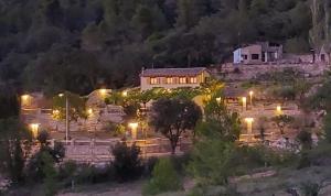 a house sitting on top of a hill at night at La Calma Montblanc Prenafeta in Prenafeta