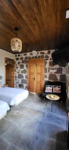 a bedroom with a bed and a stone wall at El Batan Resort in Santa Brígida