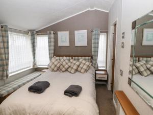 a bedroom with a bed with two pillows on it at No 7 Skiddaw View in Cockermouth