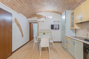 a kitchen and dining room with a table and chairs at Leone Acciaioli - YourPlace Abruzzo in Ortona