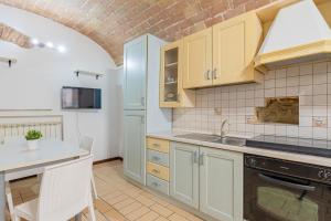 a kitchen with a sink and a stove top oven at Leone Acciaioli - YourPlace Abruzzo in Ortona