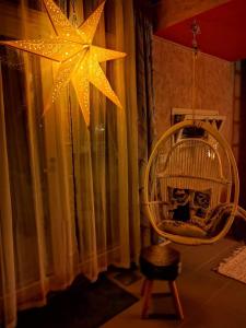 a room with a chair and a large star at Mini house Imatra with own garden in Imatra