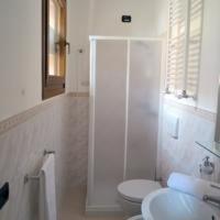 a white bathroom with a toilet and a sink at B&B Madreperla in Gallipoli