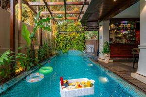 a swimming pool in the middle of a house at Riva Gold Coast in Candolim