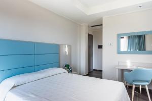 Postel nebo postele na pokoji v ubytování LUAL Bleisure Hotel