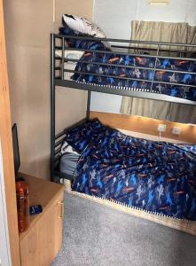 a room with three bunk beds in a dorm at Disabled 4 Berth in Ingoldmells