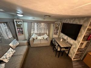 a living room with a couch and a table at Disabled 4 Berth in Ingoldmells