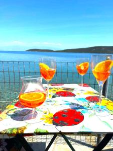 a table with four glasses of orange juice on it at Little Bit Of Heaven in Soúrpi