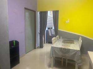 a room with a table and chairs and a window at ANGGUN HOMESTAY Banting in Banting +18 photos