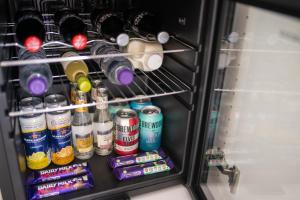 a refrigerator filled with lots of drinks and soda at The Koko Rooms in Inverness