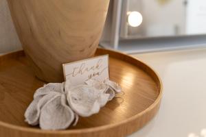 a wooden bowl with a thank you sign and towels at The Koko Rooms in Inverness +36 photos