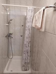 a bathroom with a shower with a shower curtain at Prenoćište San Rooms in Livno