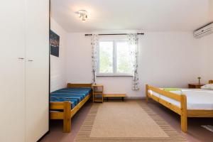Posteľ alebo postele v izbe v ubytovaní Apartments Krizmanić