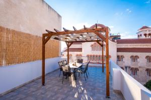 a patio with a table and chairs on a balcony at Bright Apartment In Piraeus in Piraeus