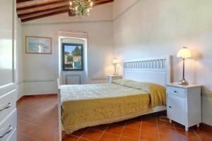 a bedroom with a bed and a chandelier at Villa Stella - Homelike Villas in Figline Valdarno +10 photos