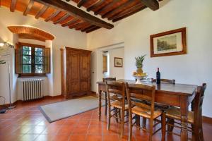 a dining room with a wooden table and chairs at Villa Stella - Homelike Villas in Figline Valdarno