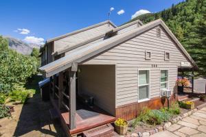 a tiny house with a garage in a yard at Mountainside Inn 217 Hotel Room in Telluride