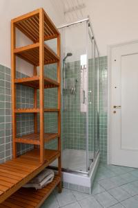 a bathroom with a shower with green tiles at Appartamento Gramsci by Wonderful Italy in Bologna