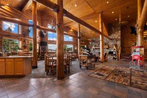 a large room with wooden ceilings and tables and chairs at Best Western Northwoods Lodge in Siren