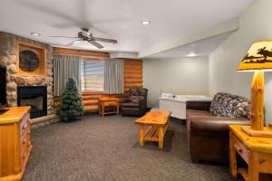 a living room with a couch and a fireplace at Best Western Northwoods Lodge in Siren