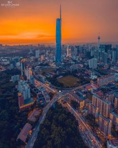 an aerial view of a city at sunset at Grand Residence Suite At Opus Kuala Lumpur in Kuala Lumpur
