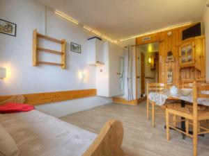 a room with a bed and a table and a dining room at Studio Les Arcs 1800, 1 pièce, 3 personnes - FR-1-346-473 in Arc 1800