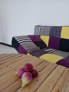 a wooden table with vegetables on top of a couch at Beach & Sunset villa in Mboro
